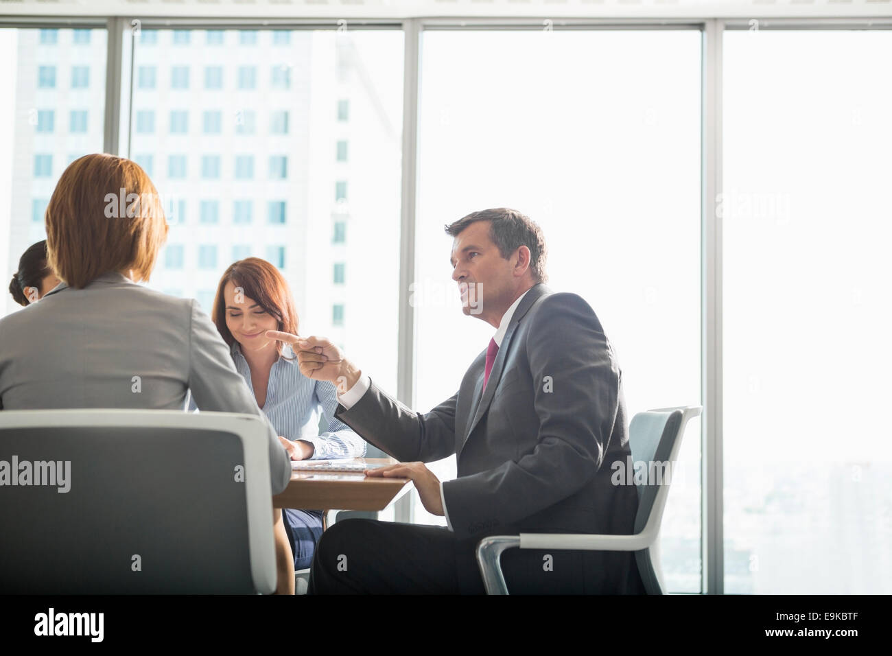 Businessman discussing with female team in conference room Stock Photo