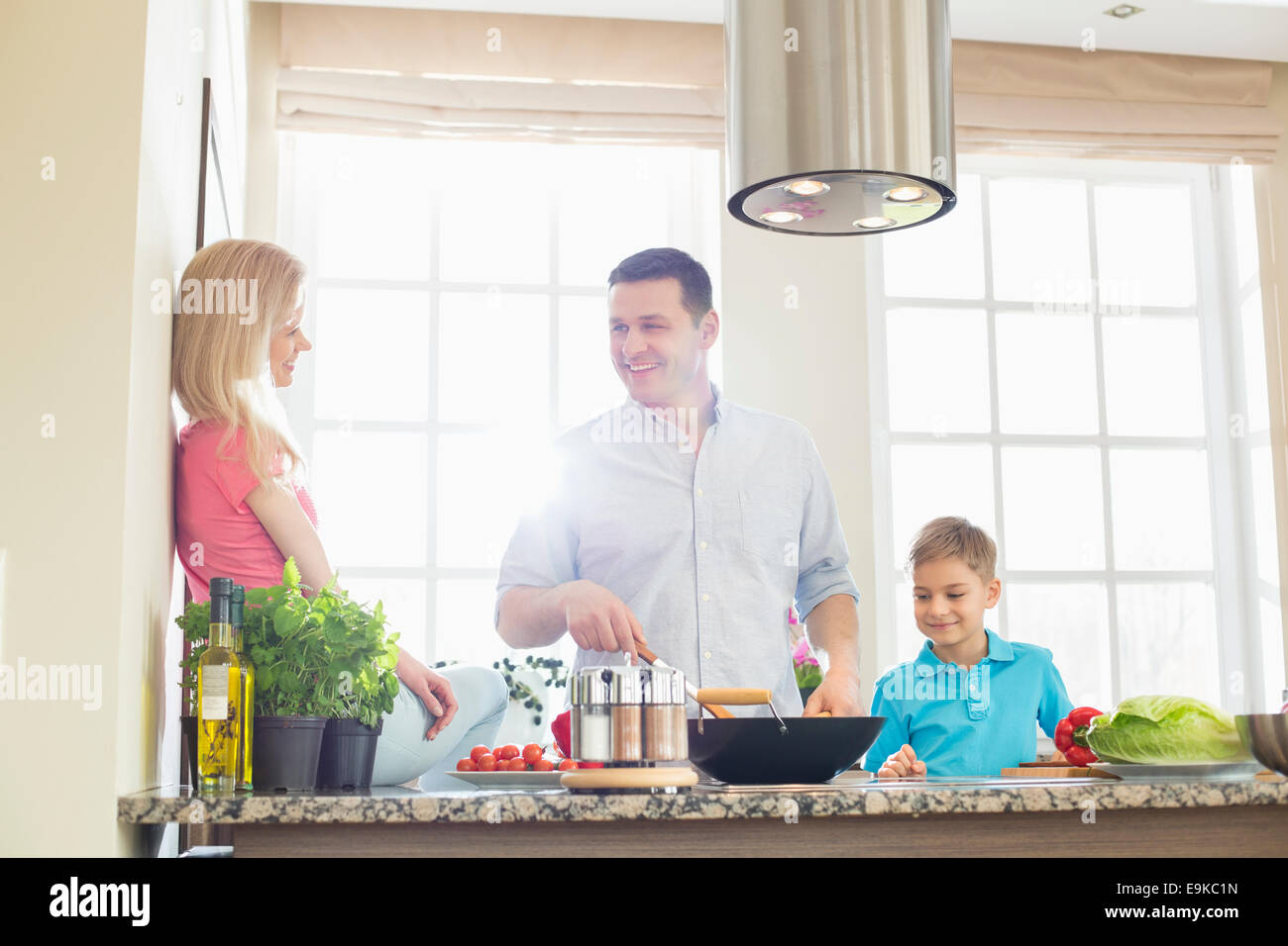 Family preparing food in kitchen Stock Photo