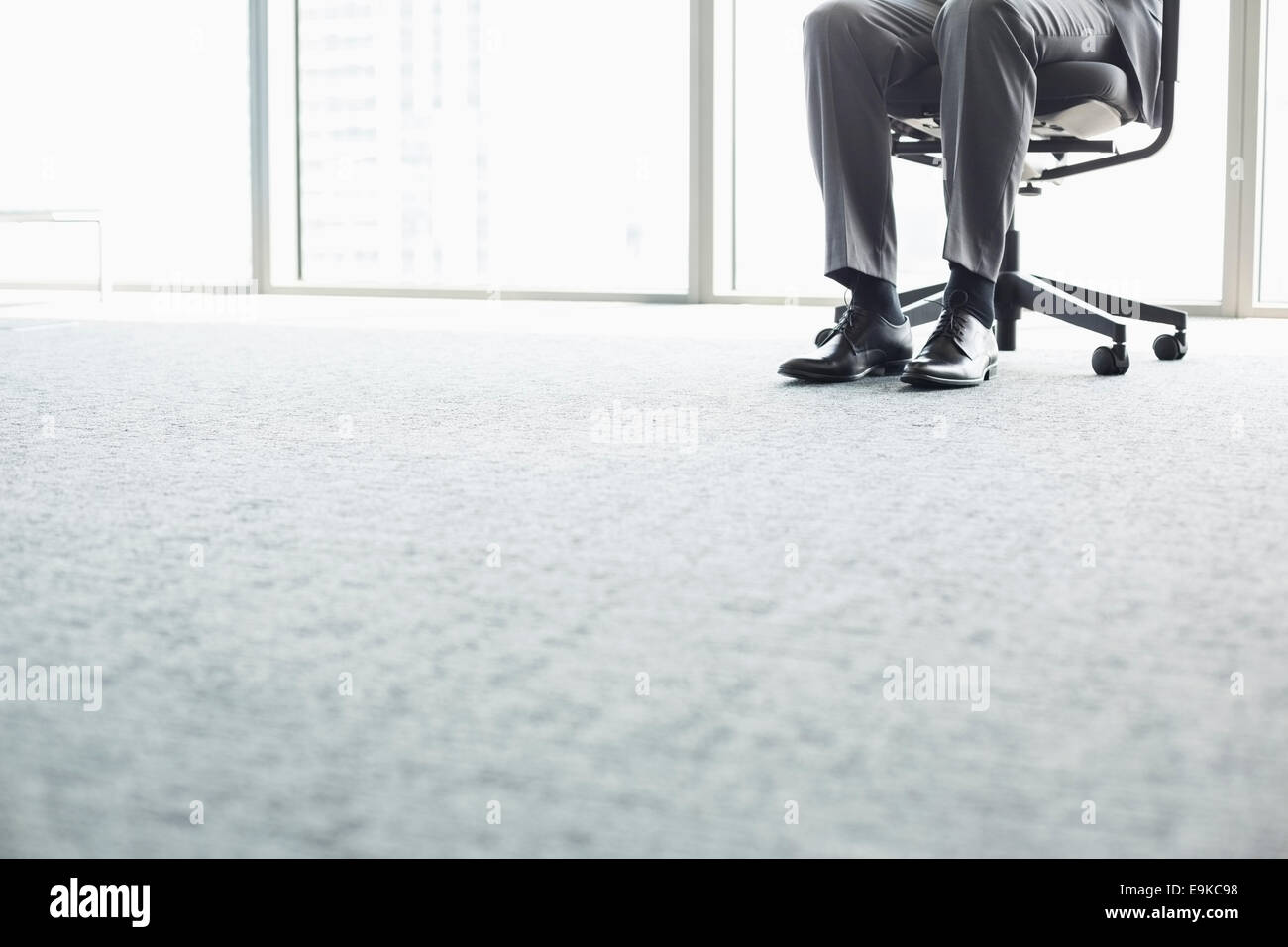 Low section of businessman sitting on office chair Stock Photo