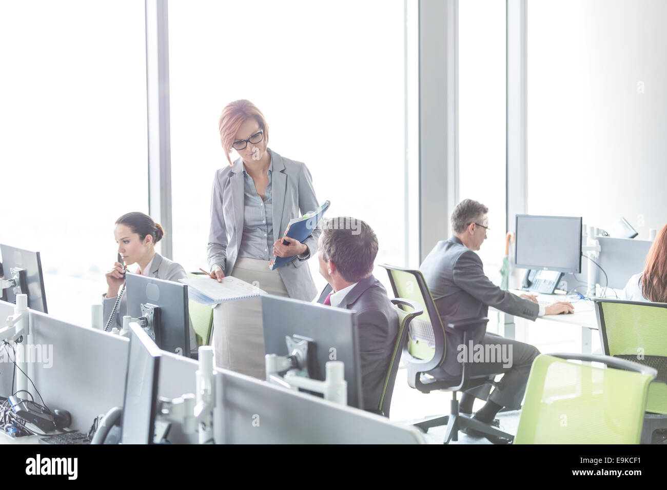 Business people working in open plan office Stock Photo