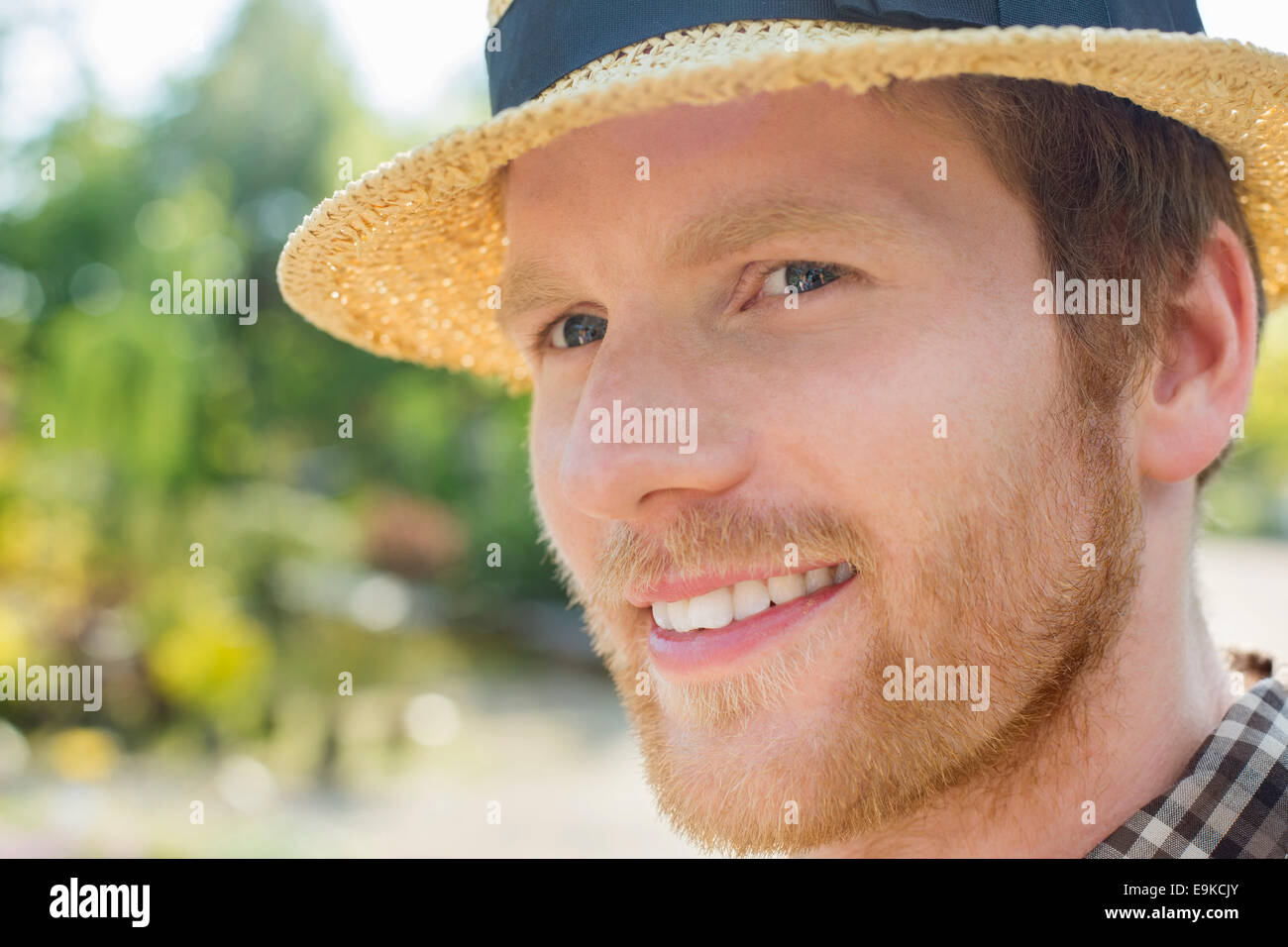 Close-up of gardener smiling while looking away Stock Photo