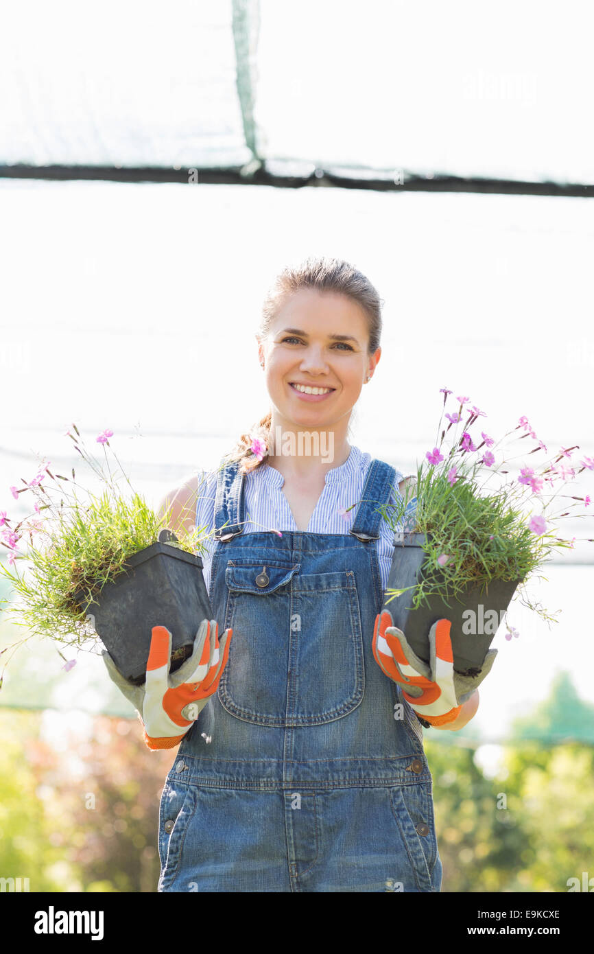 Female gardener holding potted hi-res stock photography and images - Alamy