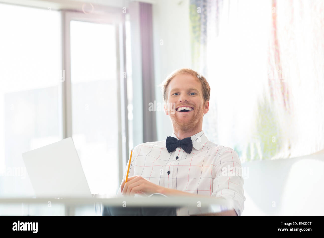 Man laughing sitting desk hi-res stock photography and images - Alamy