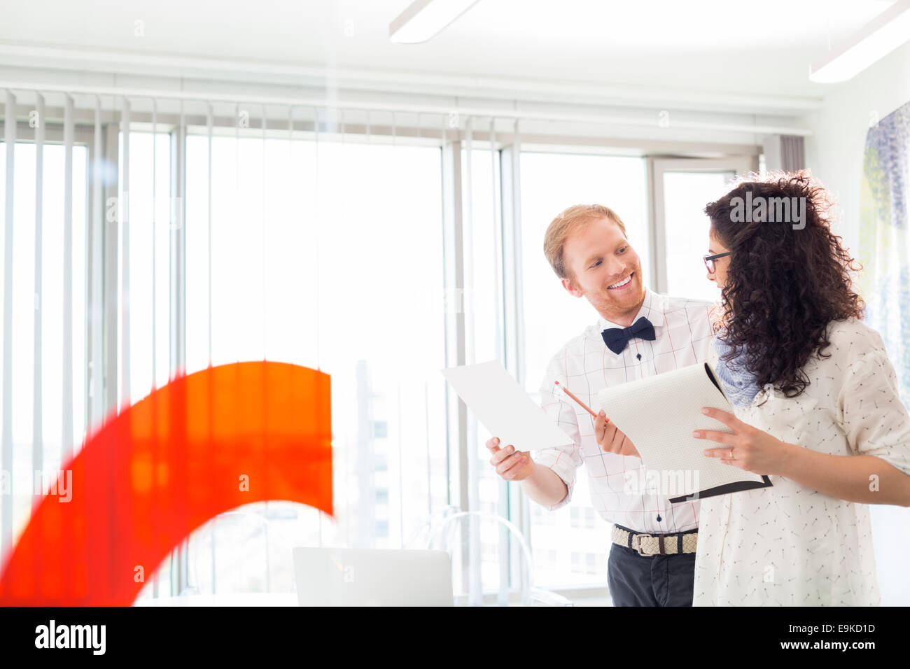 Businesspeople discussing in creative office Stock Photo