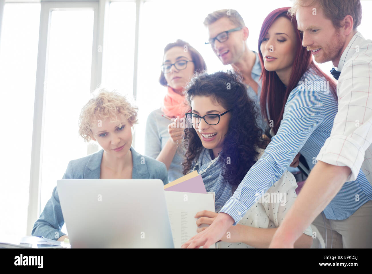 Group of creative businesspeople using laptop in office Stock Photo