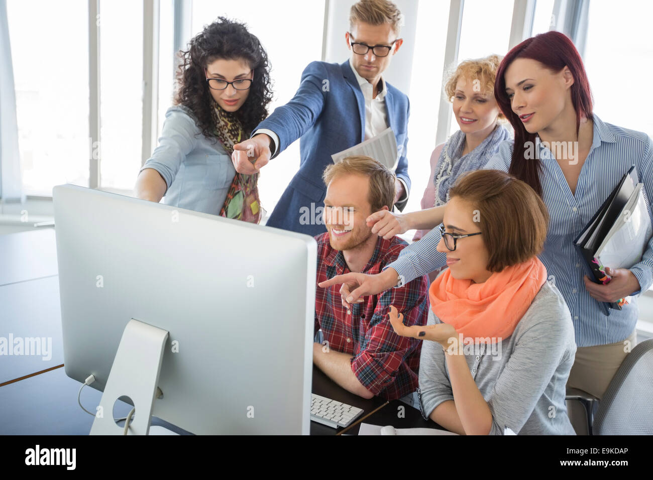 Creative people using desktop smiling hi-res stock photography and ...