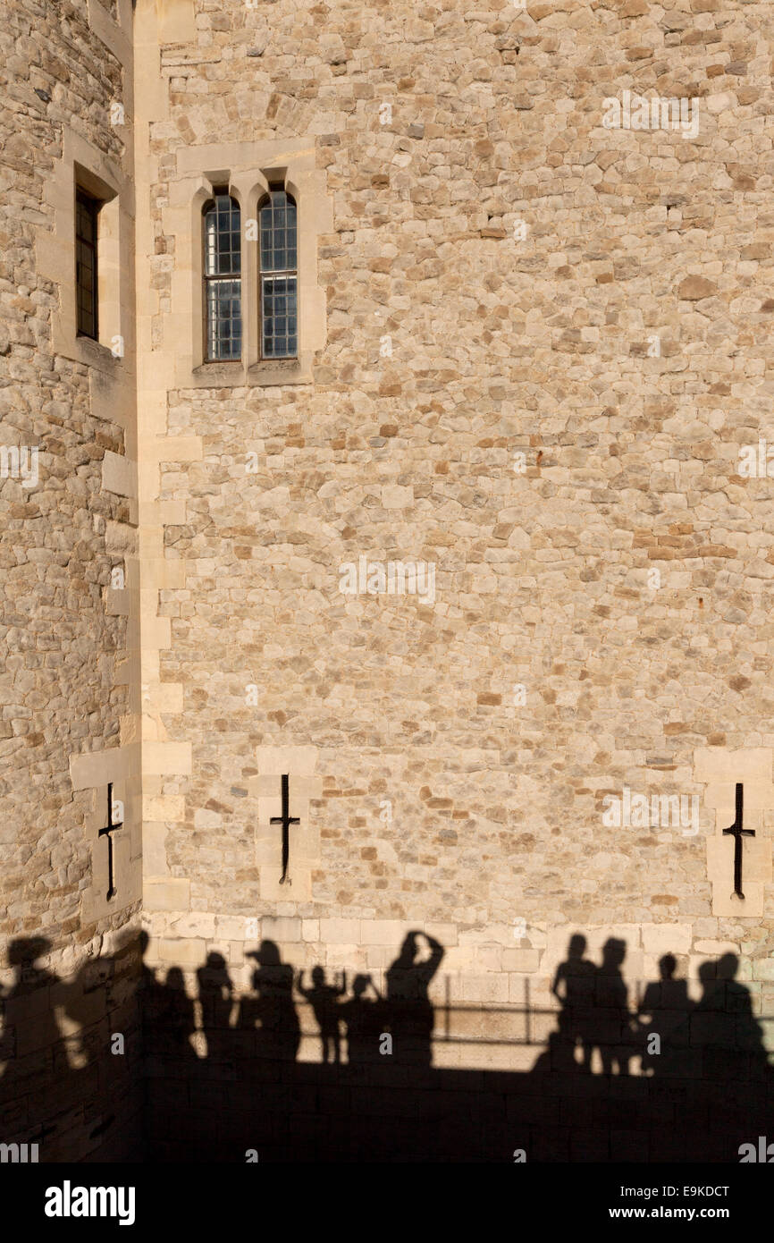 Shadows of tourists on the wall at the Tower of London, London, England UK Stock Photo