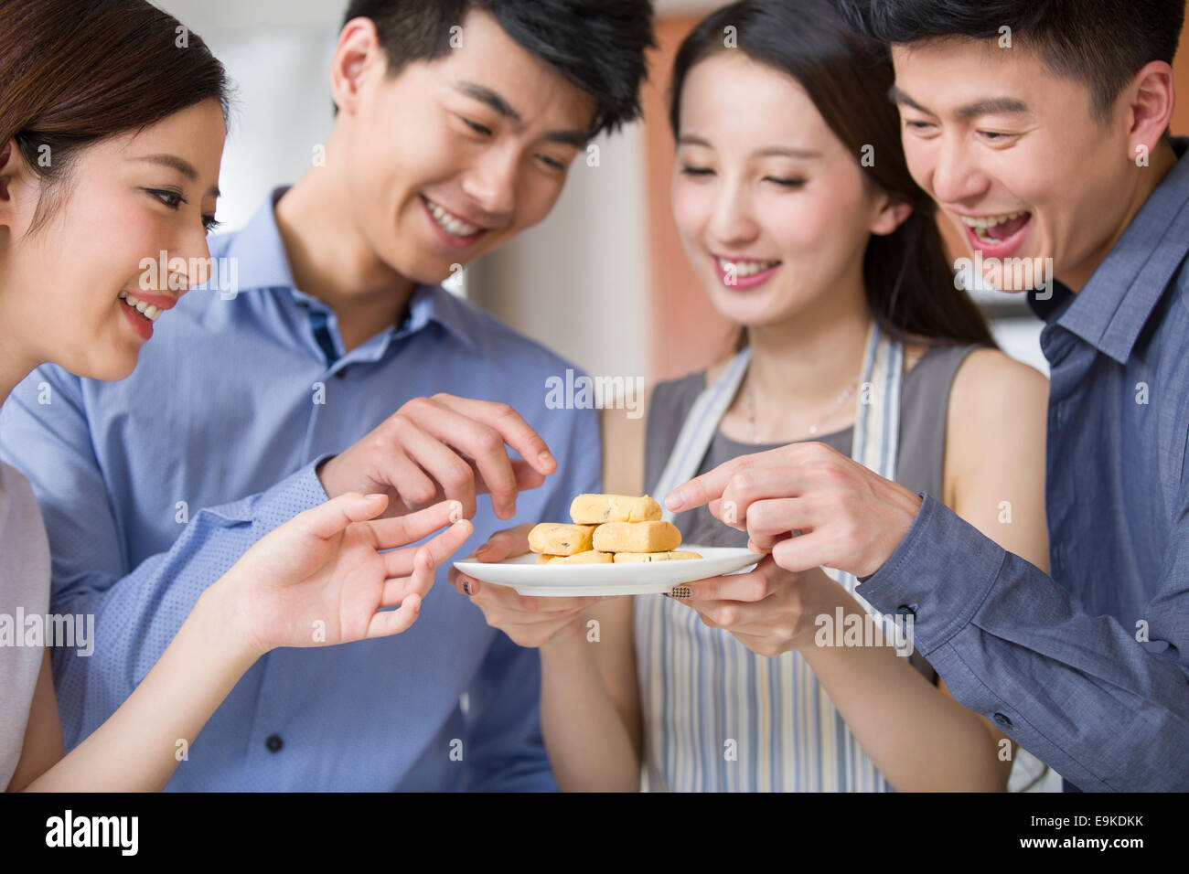 Young woman serving snacks for her friends Stock Photo Alamy
