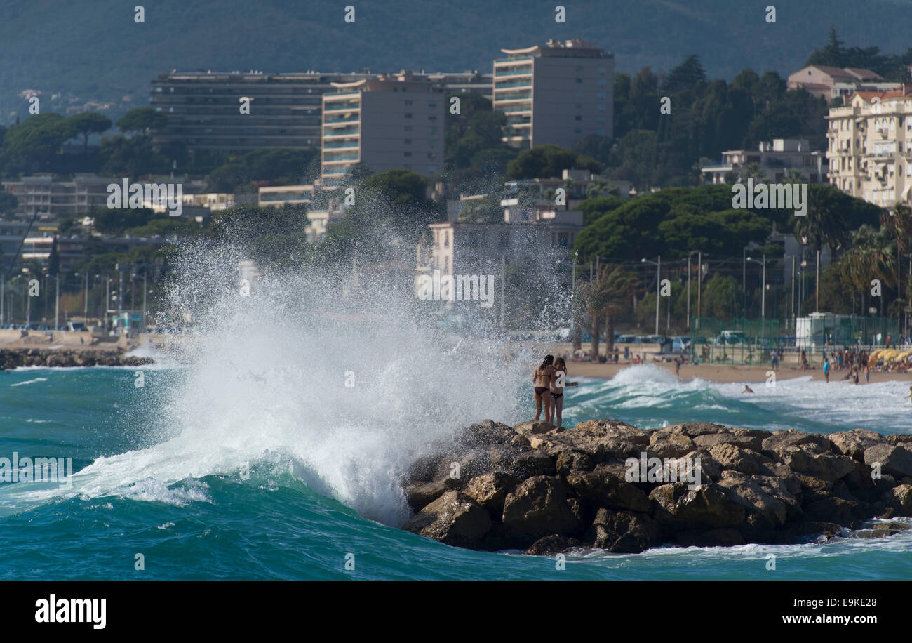 Waves crash against rocks on a beach in Cannes, South of France. Stock Photo