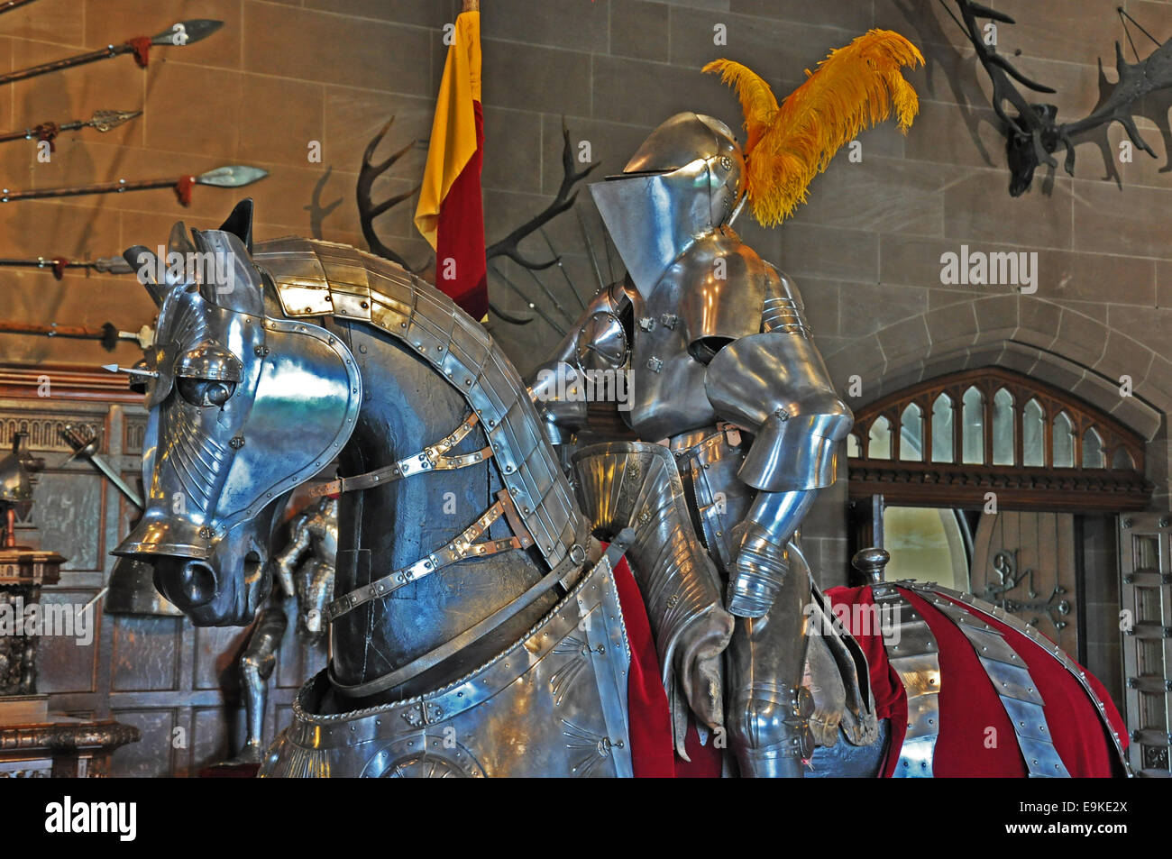Warwick Castle - a model knight on horse, both in shining armour, on display. England, UK. Stock Photo