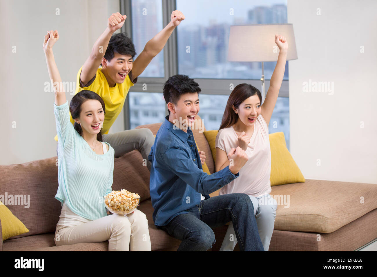 Cheerful young adults watching sports games on TV Stock Photo Alamy