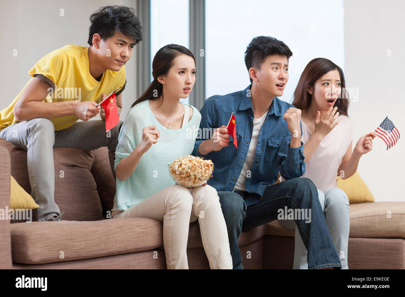 Young adults watching sports games on TV Stock Photo Alamy