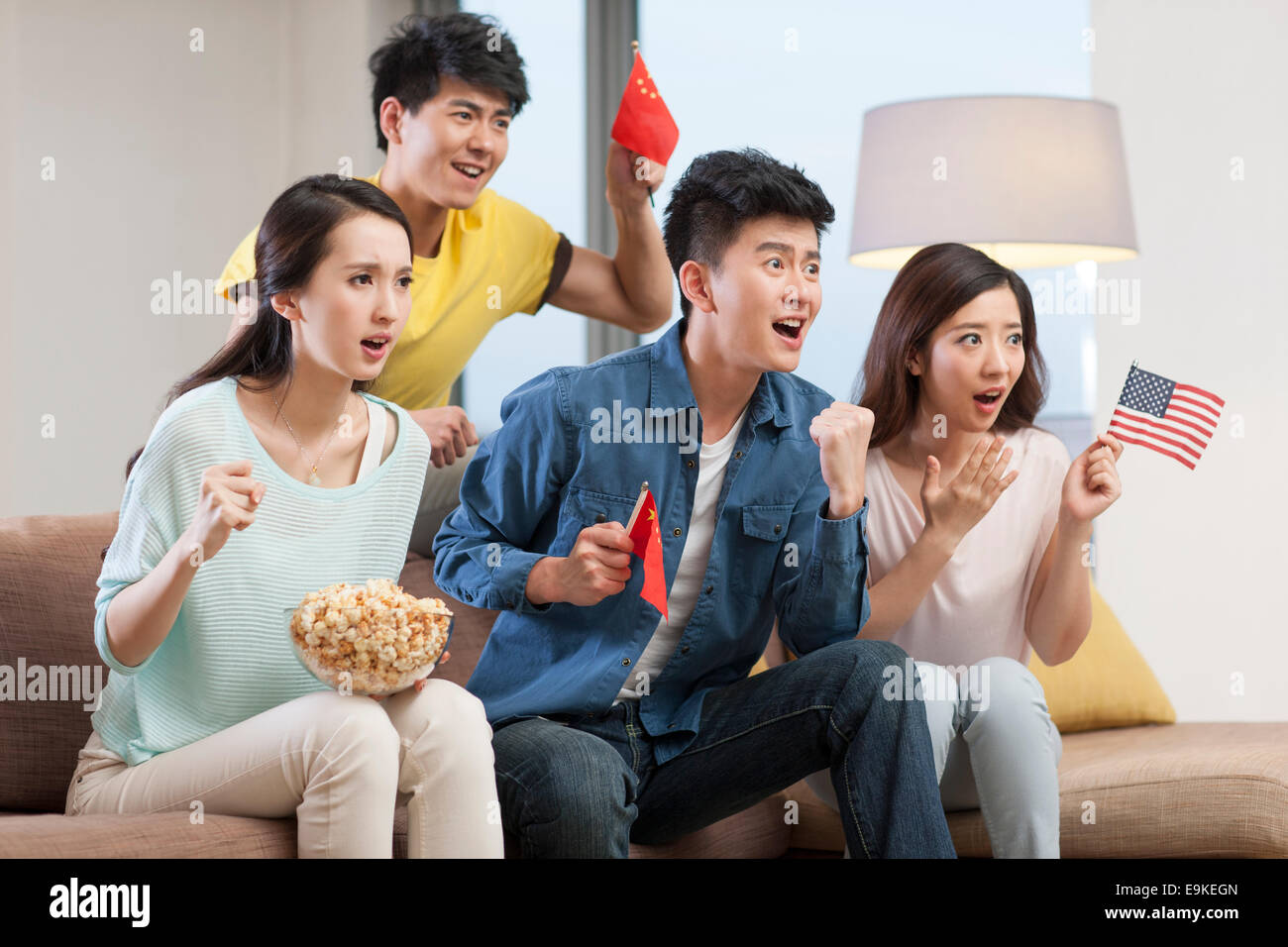 Young adults watching sports games on TV Stock Photo Alamy