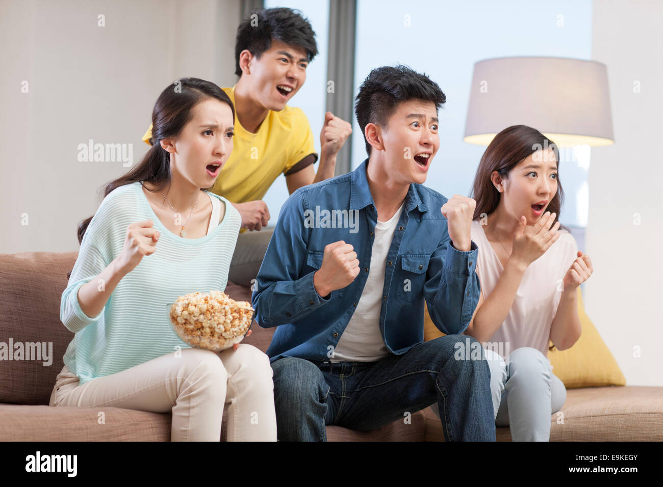 Young adults watching sports games on TV Stock Photo Alamy