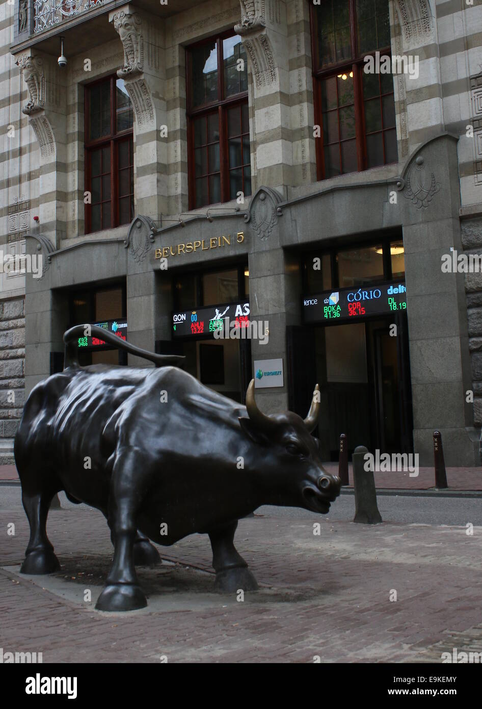 Amsterdam stock Exchange building at Beursplein in the Dutch capital.  In front a statue of a bull by sculptor Arturo Di Modica Stock Photo