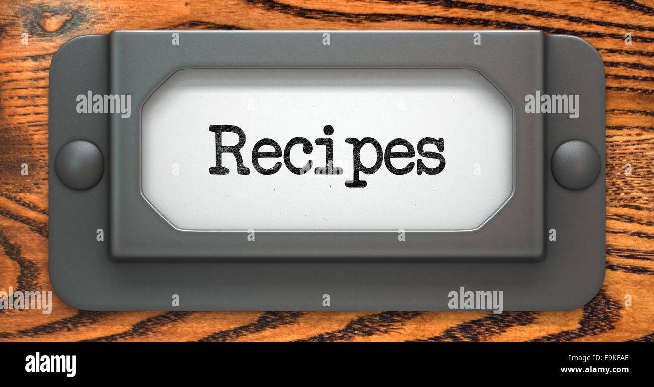 Recipes - Inscription on File Drawer Label on a Wooden Background. Stock Photo