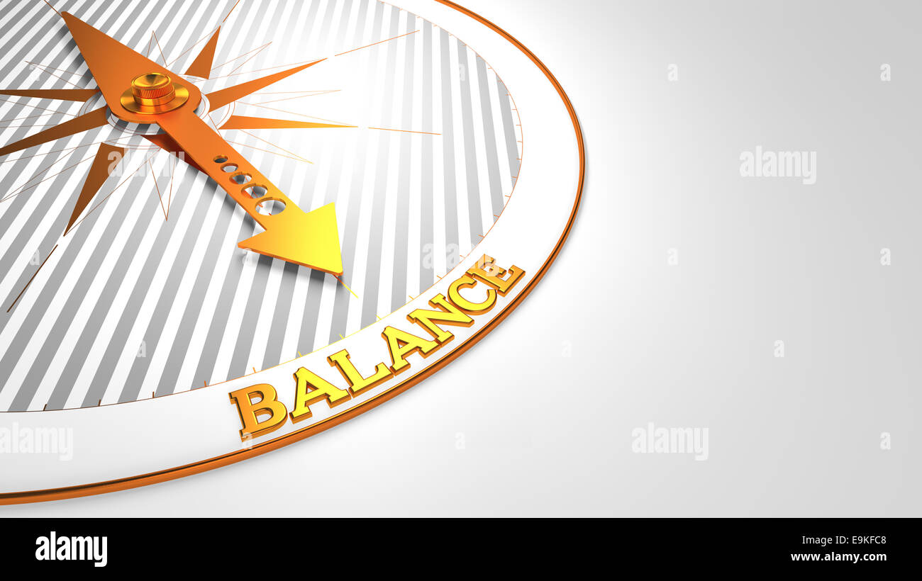 Balance - Golden Compass Needle on a White Field Pointing. Stock Photo