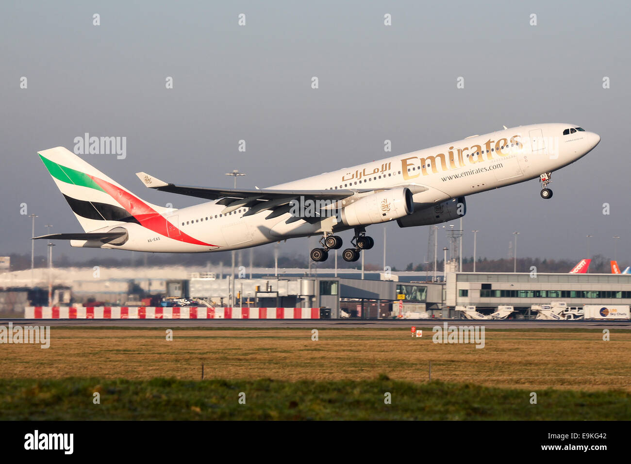 Emirates Airbus A330-200 climbs away from runway 05L at Manchester Airport. Stock Photo