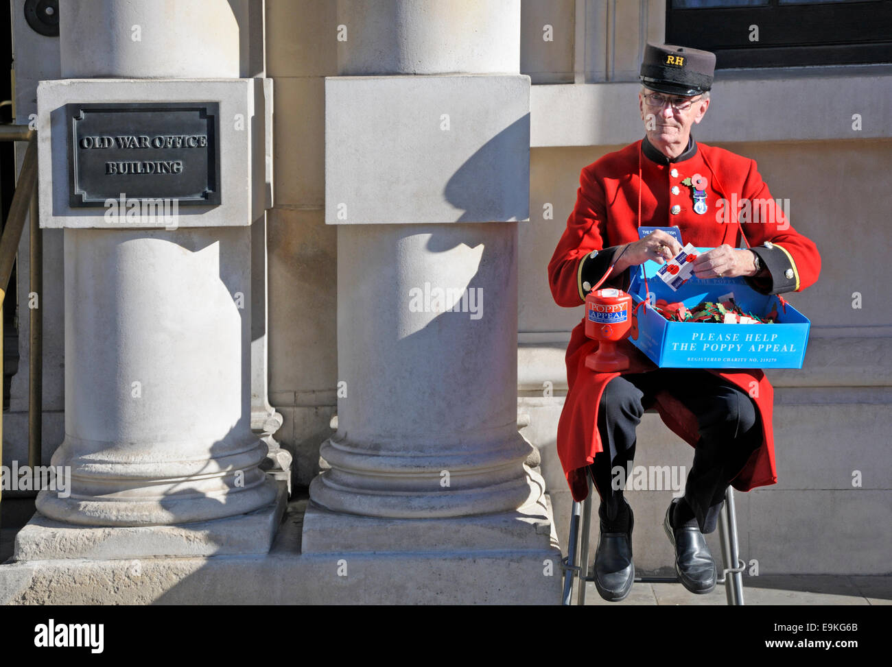 London, England, UK. Chelsea Pensioner selling poppies outside the Old War Office Building in Whitehall Stock Photo