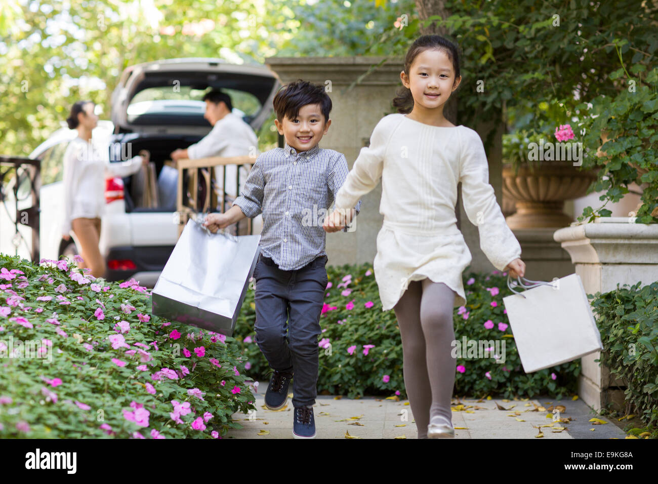 Young family coming back from shopping Stock Photo - Alamy