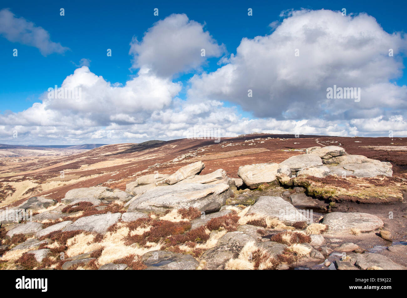 Derwent edge in bright winter sunshine. A colourful landscape of gritstone rocks and heather beneath a blue sky. Stock Photo