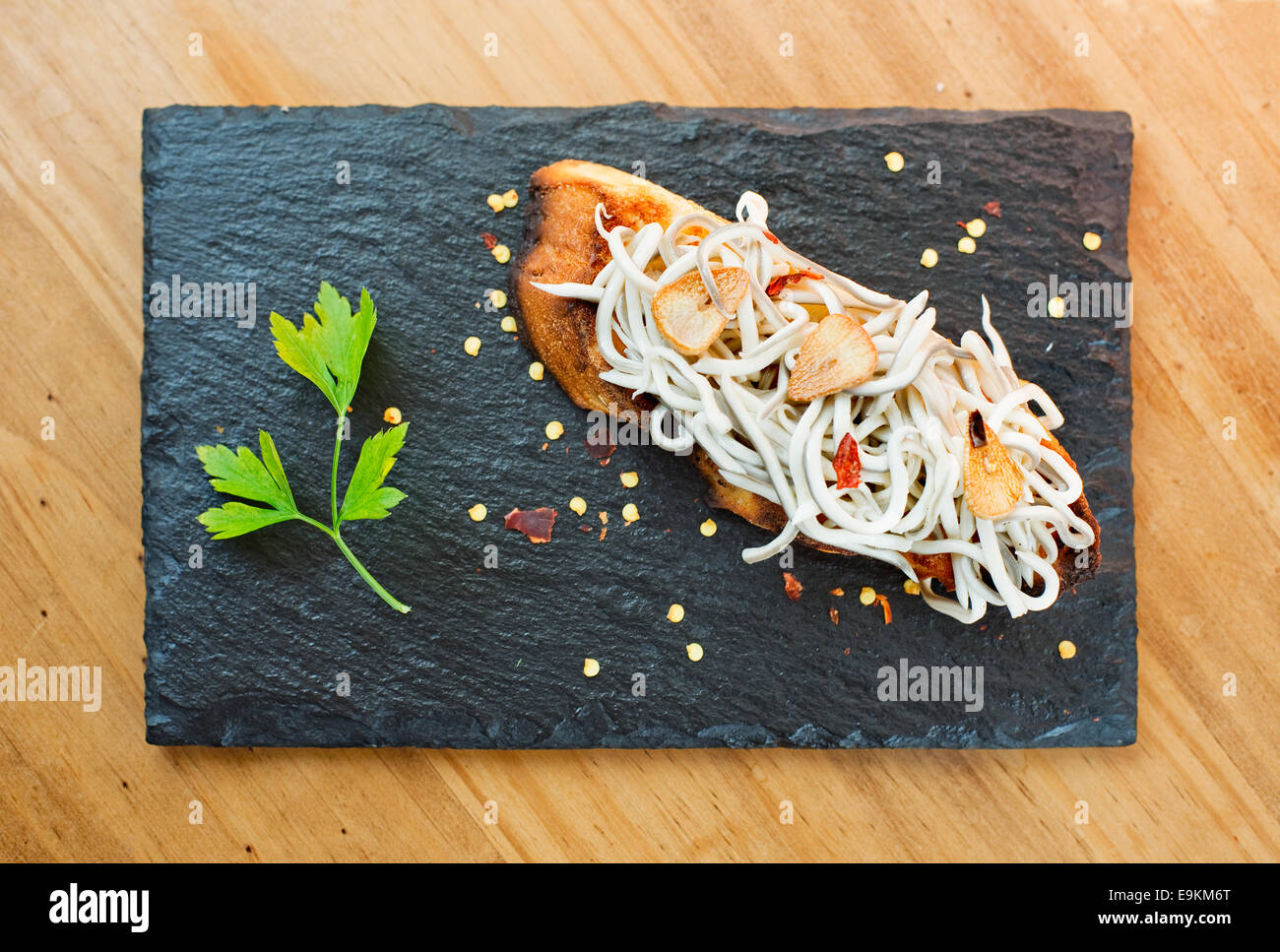 Typical spanish pincho de gulas in slate plate. (Elvers pintxo) Stock Photo
