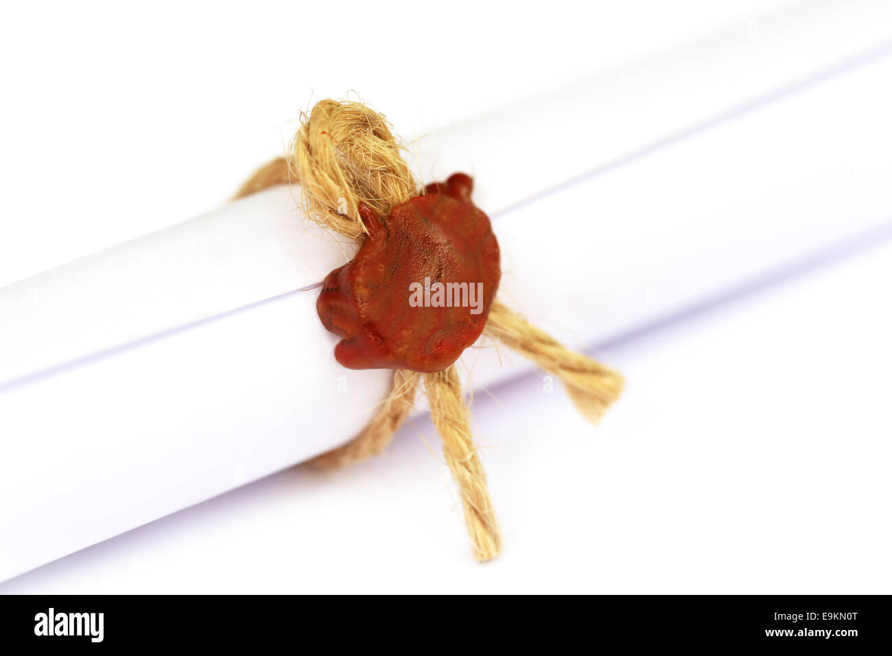 Wax seal on a rolled paper tied with roope Stock Photo