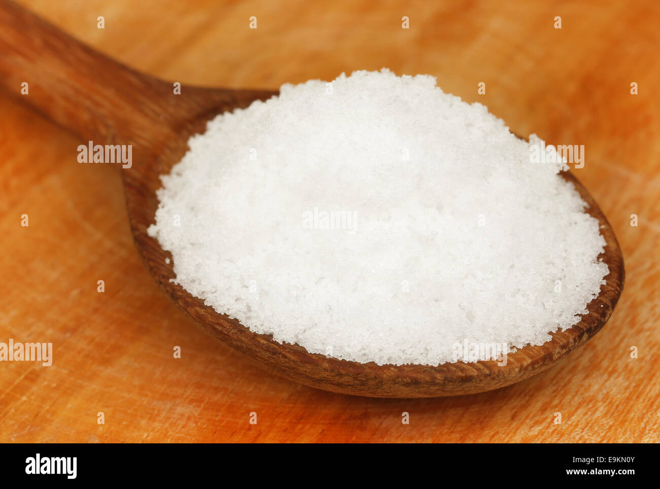 Table salt on wooden spoon Stock Photo