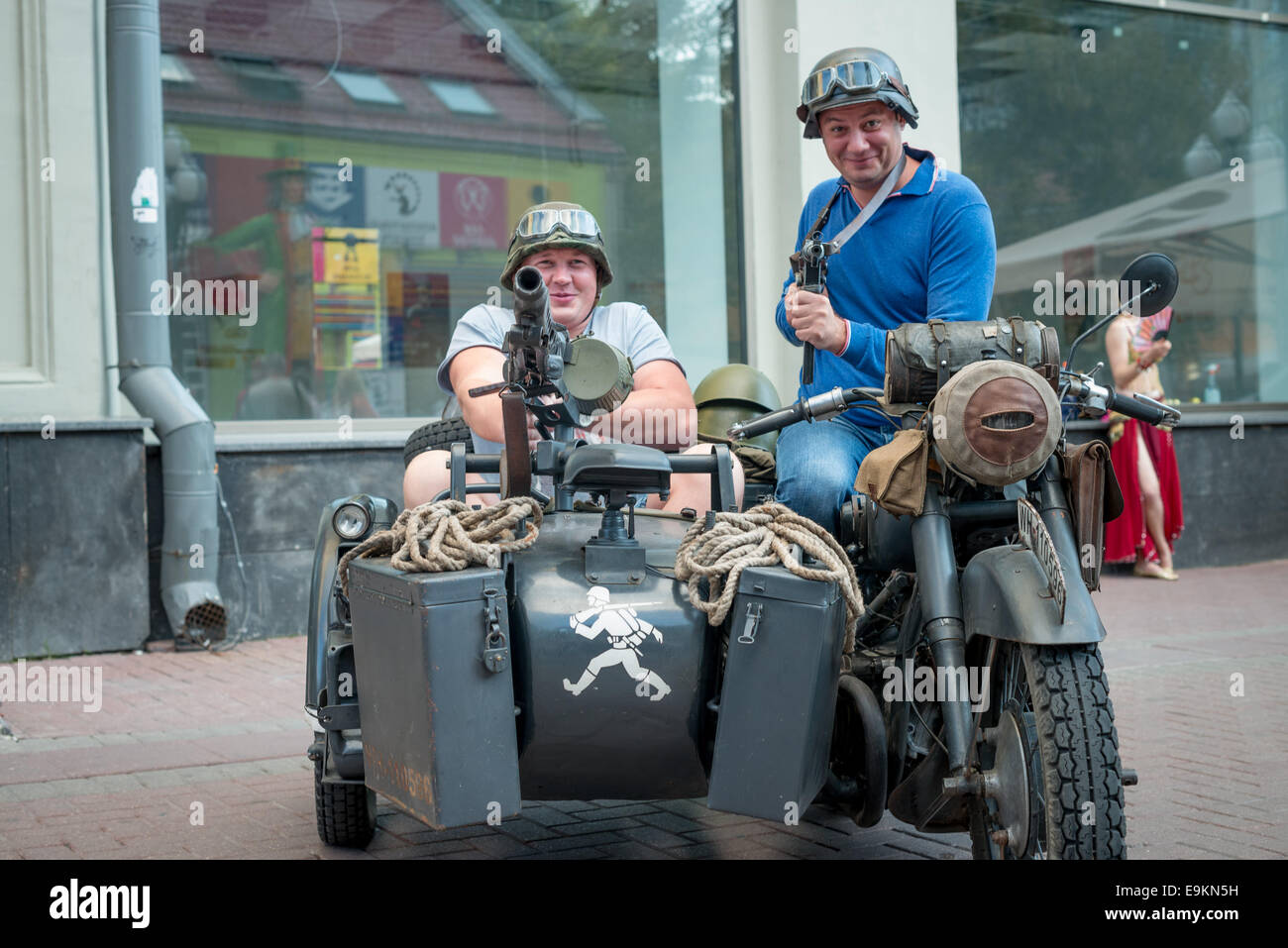 Two Russian men posing for picture in old soviet motorbike in Moscow. Stock Photo