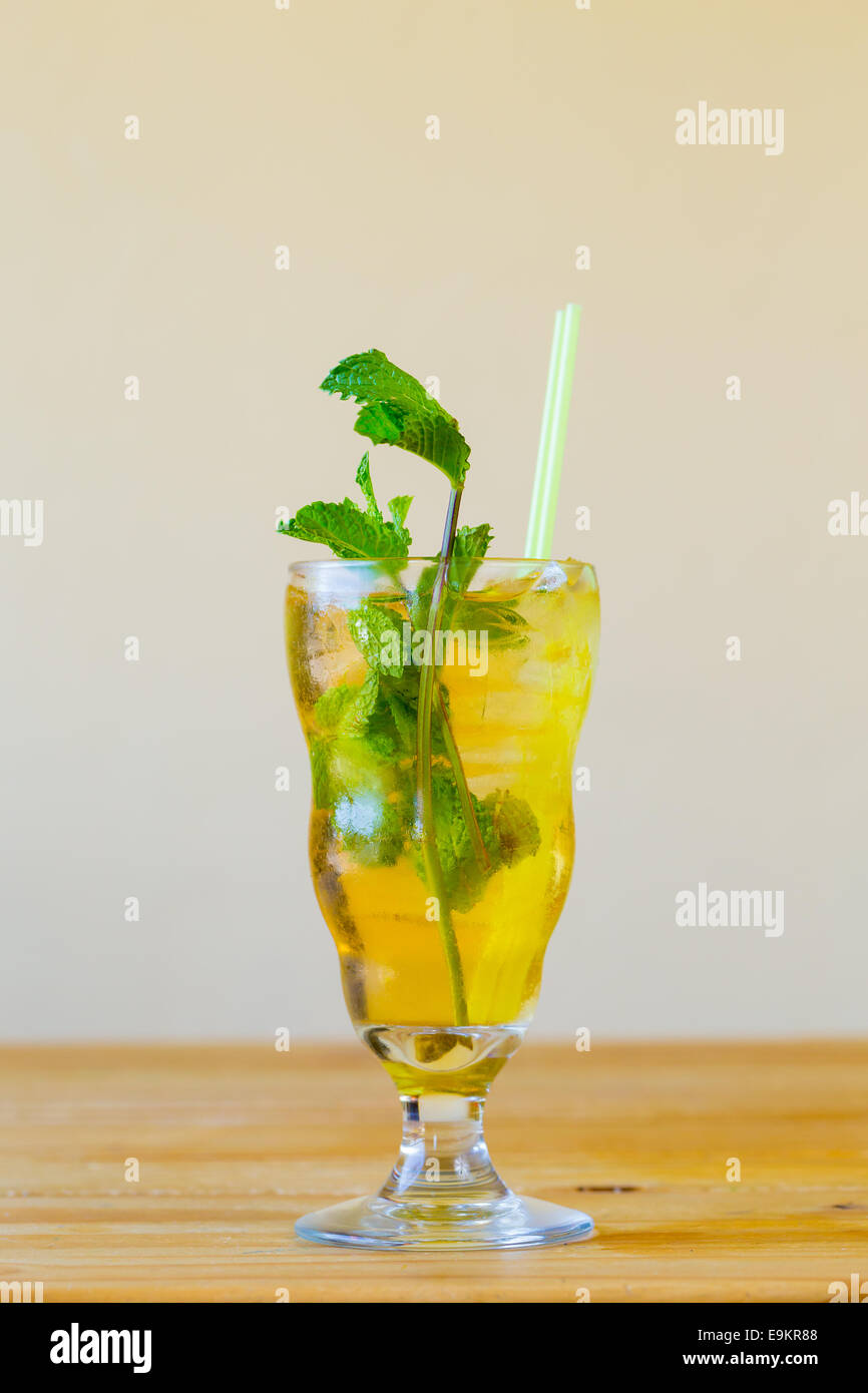 Mojito with mint in a traditional mixed drink glass served with a straw at a Mexican restaurant bar. Stock Photo
