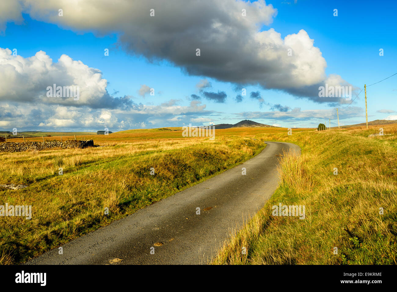 A country lane on Bodmin Moor in Cornwall with Roughtor in the far distance Stock Photo