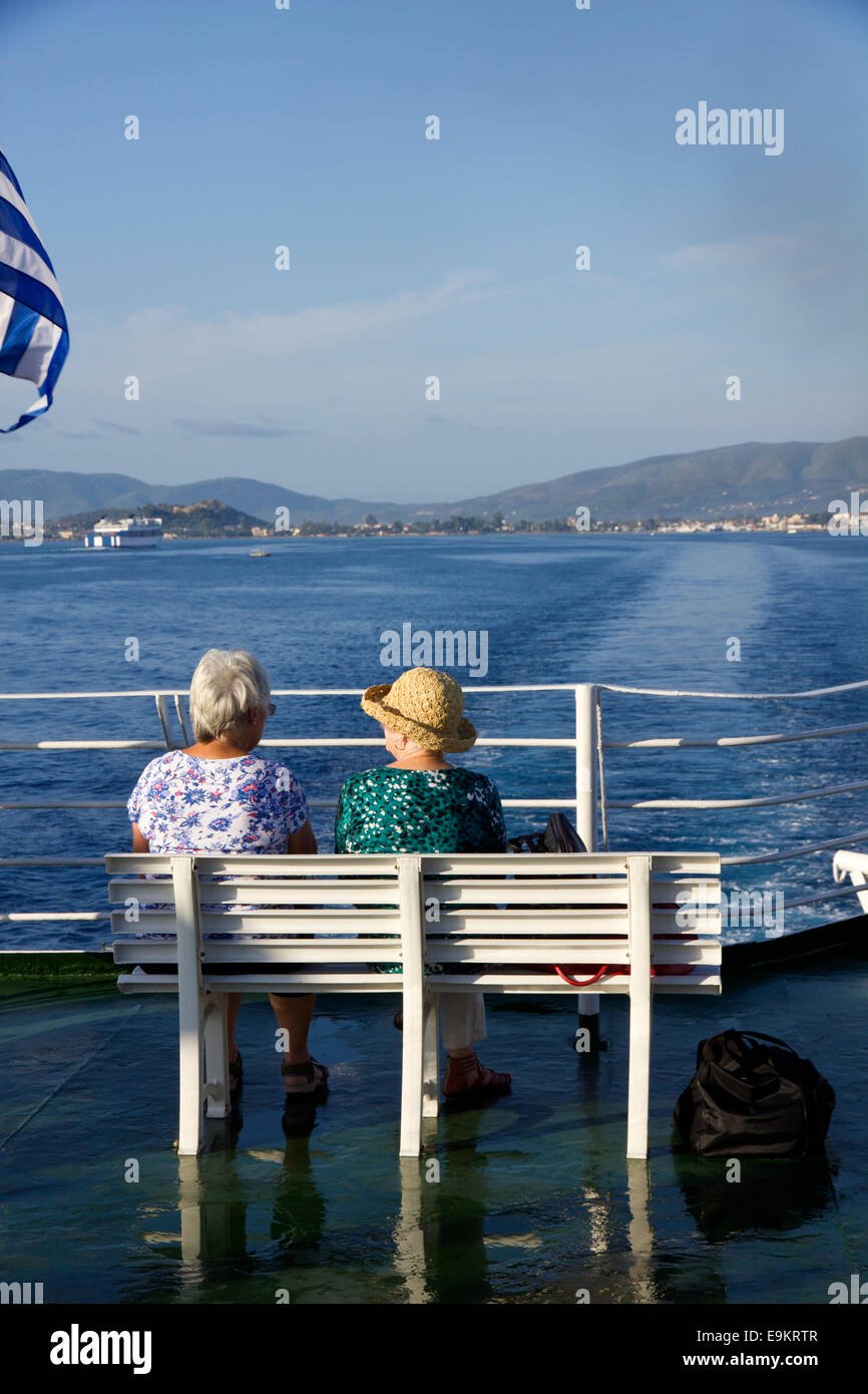 Two senior ladies in conversation sitting on a Ferry Boat in the Greek Ionian Islands Stock Photo