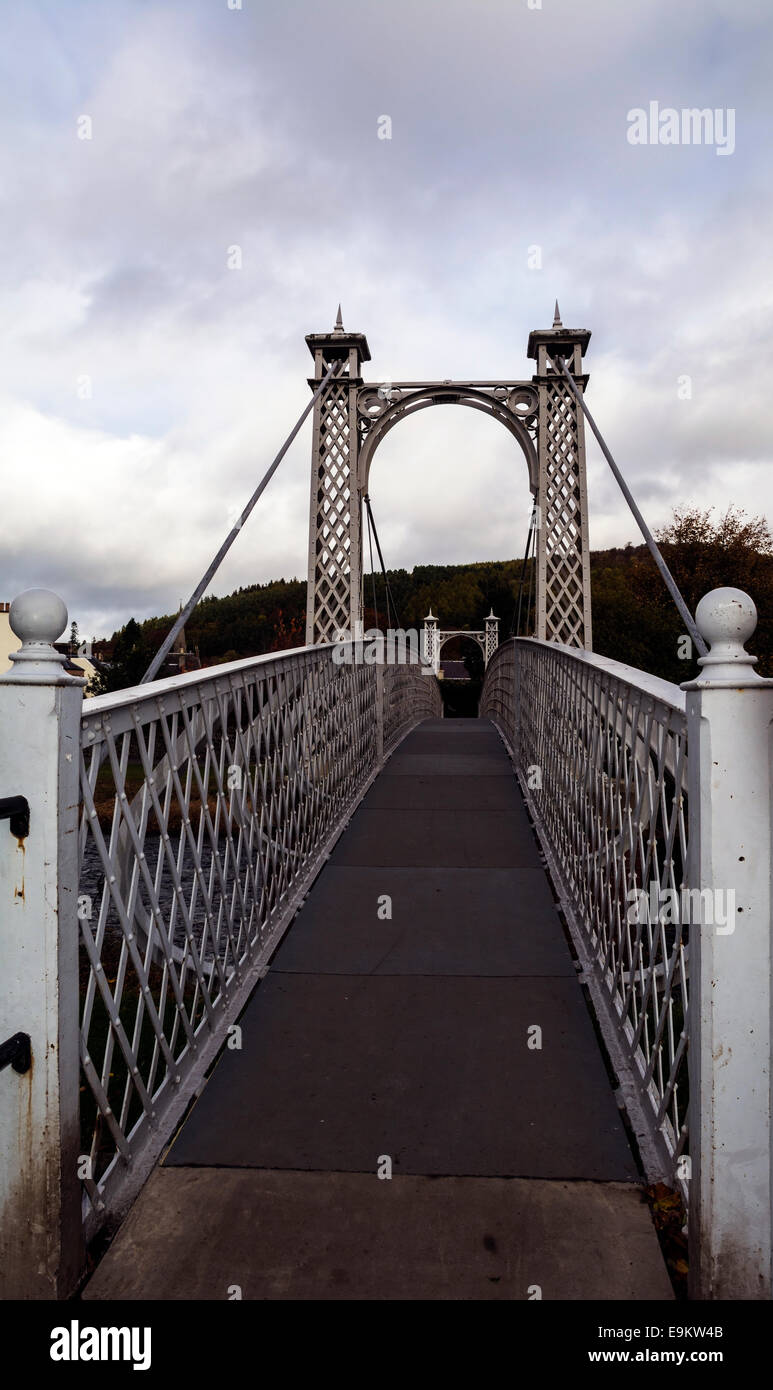 A steel cable suspension bridge built in 1905 links footpaths on either side of the River Tweed in Peebles, Scotland. Stock Photo
