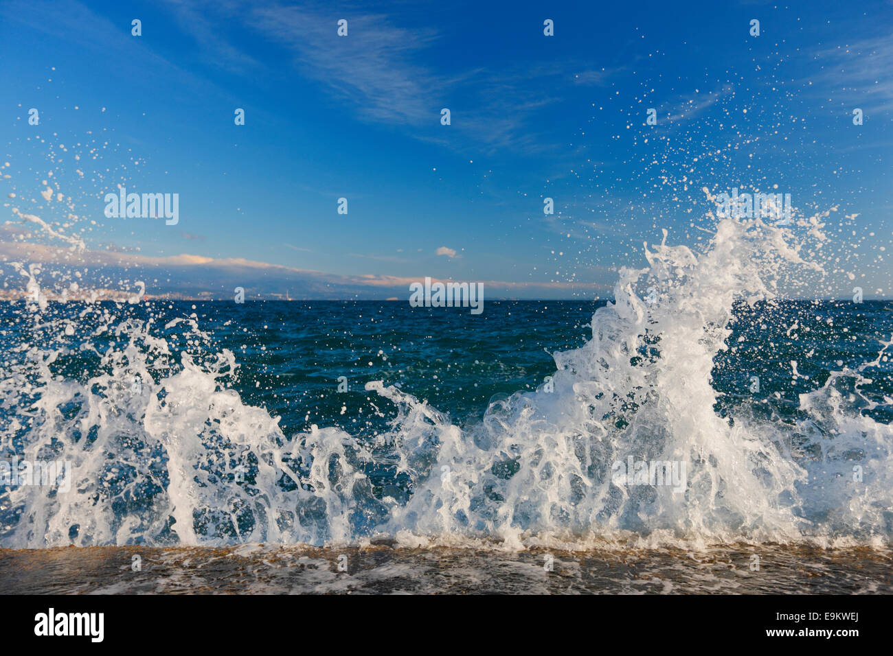 Sea waves splashing the rock on the beach Stock Photo - Alamy