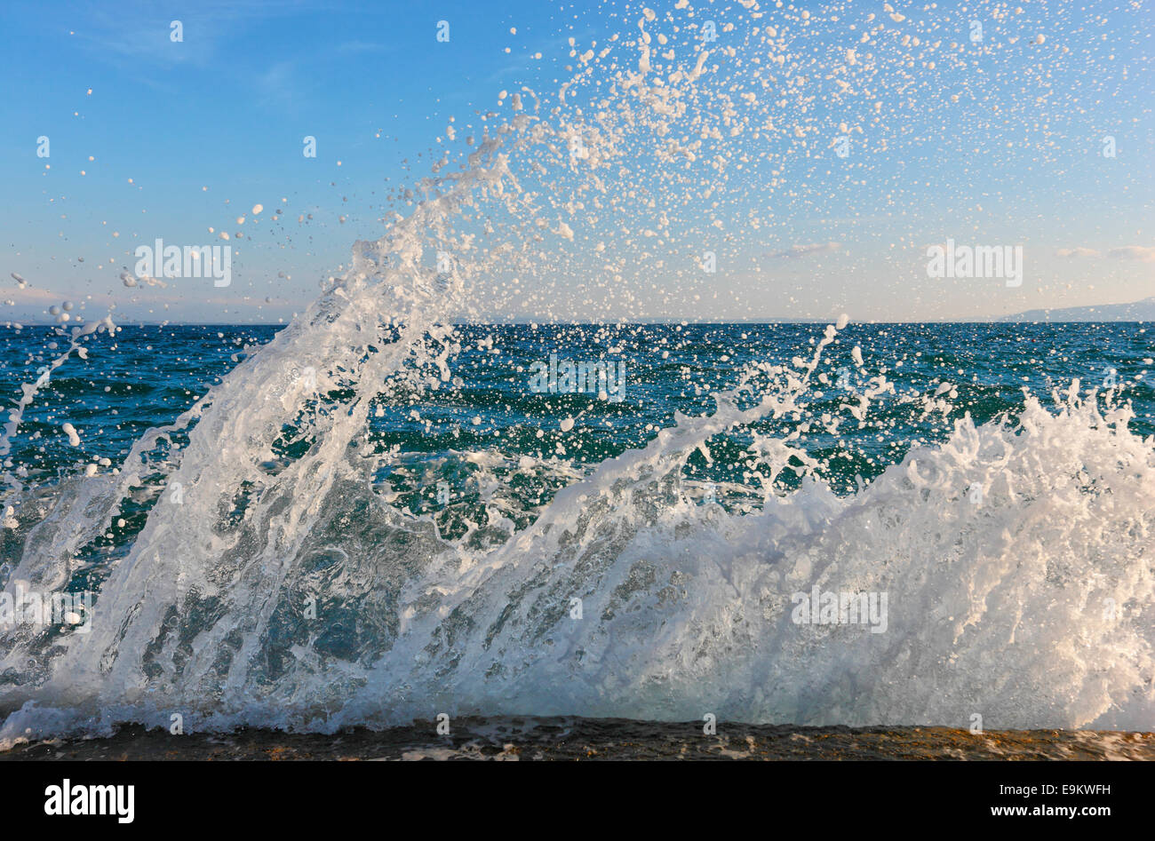 Sea waves splashing the rock on the beach Stock Photo