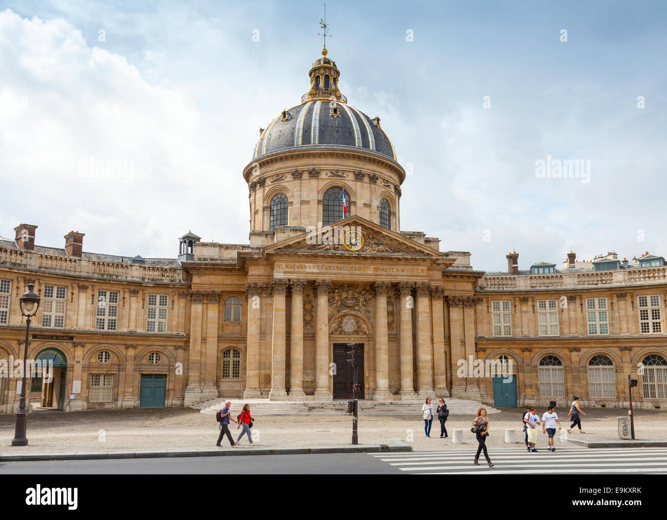 Paris, France - August 07, 2014: Tourists walking near the Institute de France in Paris. Architect Louis Le Vau, was made betwee Stock Photo