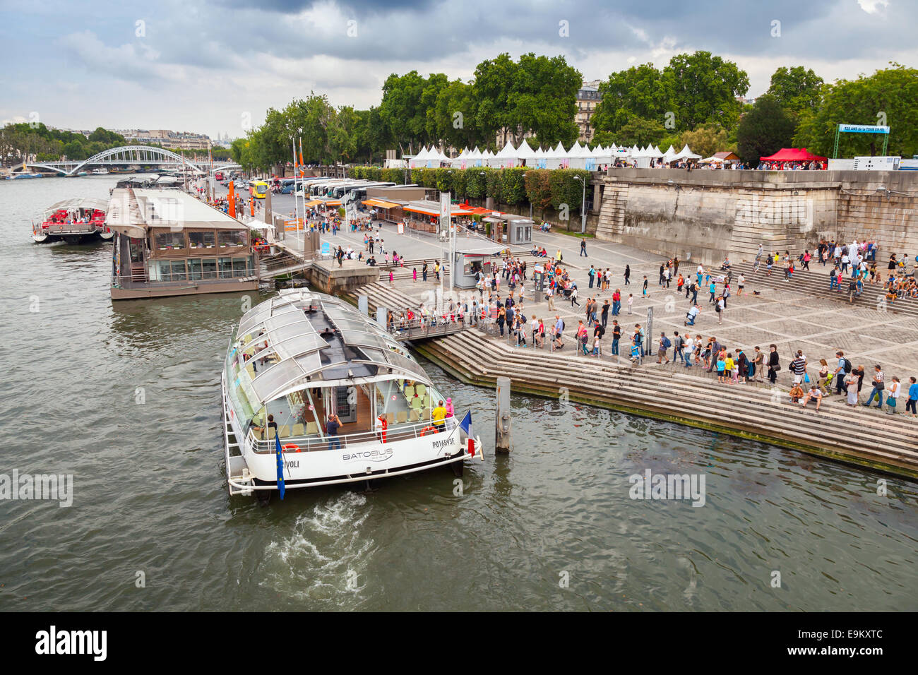 Paris, France - August 07, 2014: passenger touristic ship operated by Batobus Paris is moored to the pier near Eiffel Tower. Peo Stock Photo