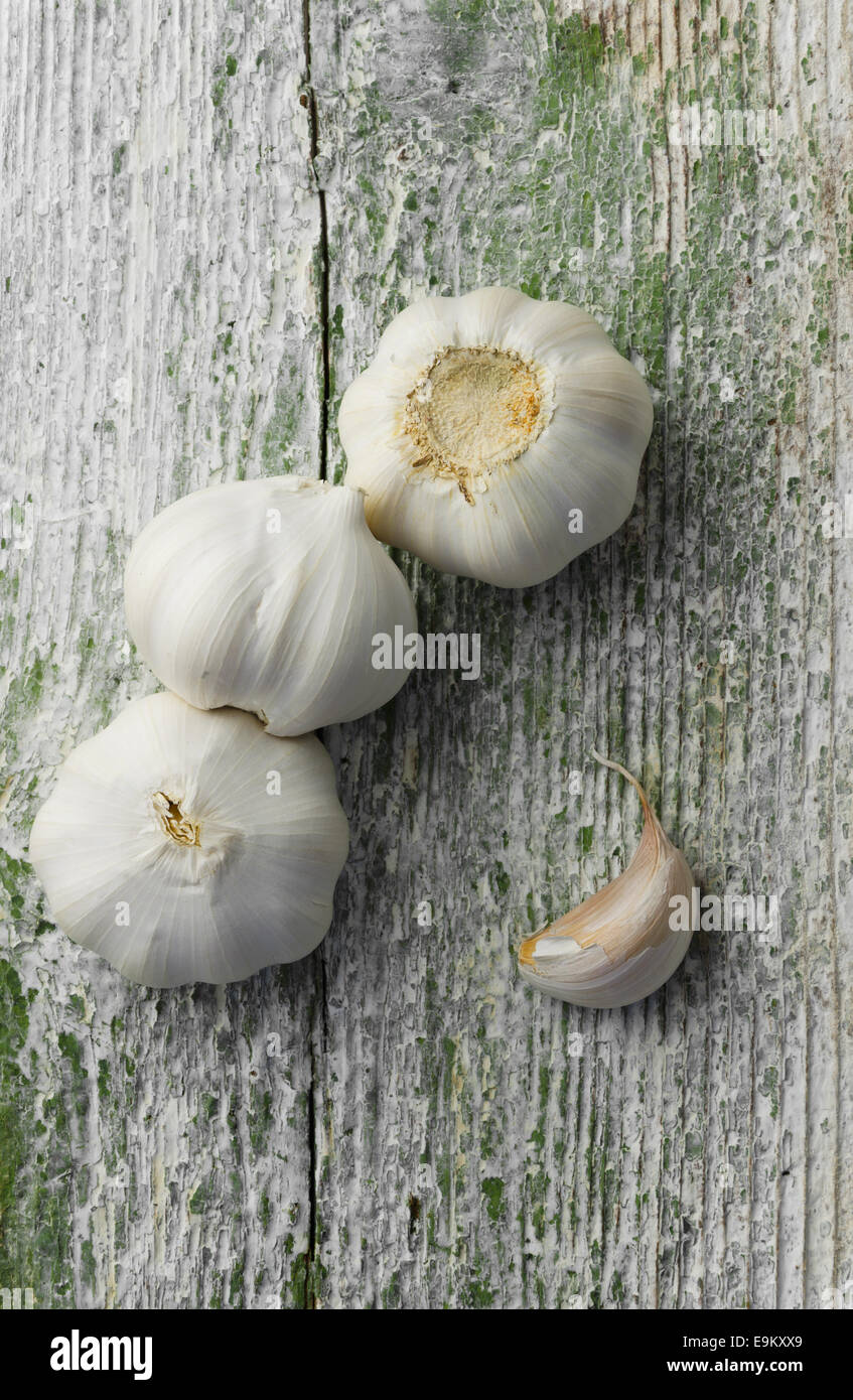 Cloves of garlic over old textured wooden background Stock Photo - Alamy