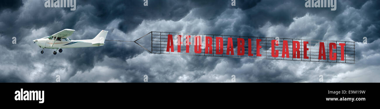 Affordable Care Act Banner: Airplane is towing a banner that reads 'Affordable Care Act' against a dramatic, stormy sky. Stock Photo