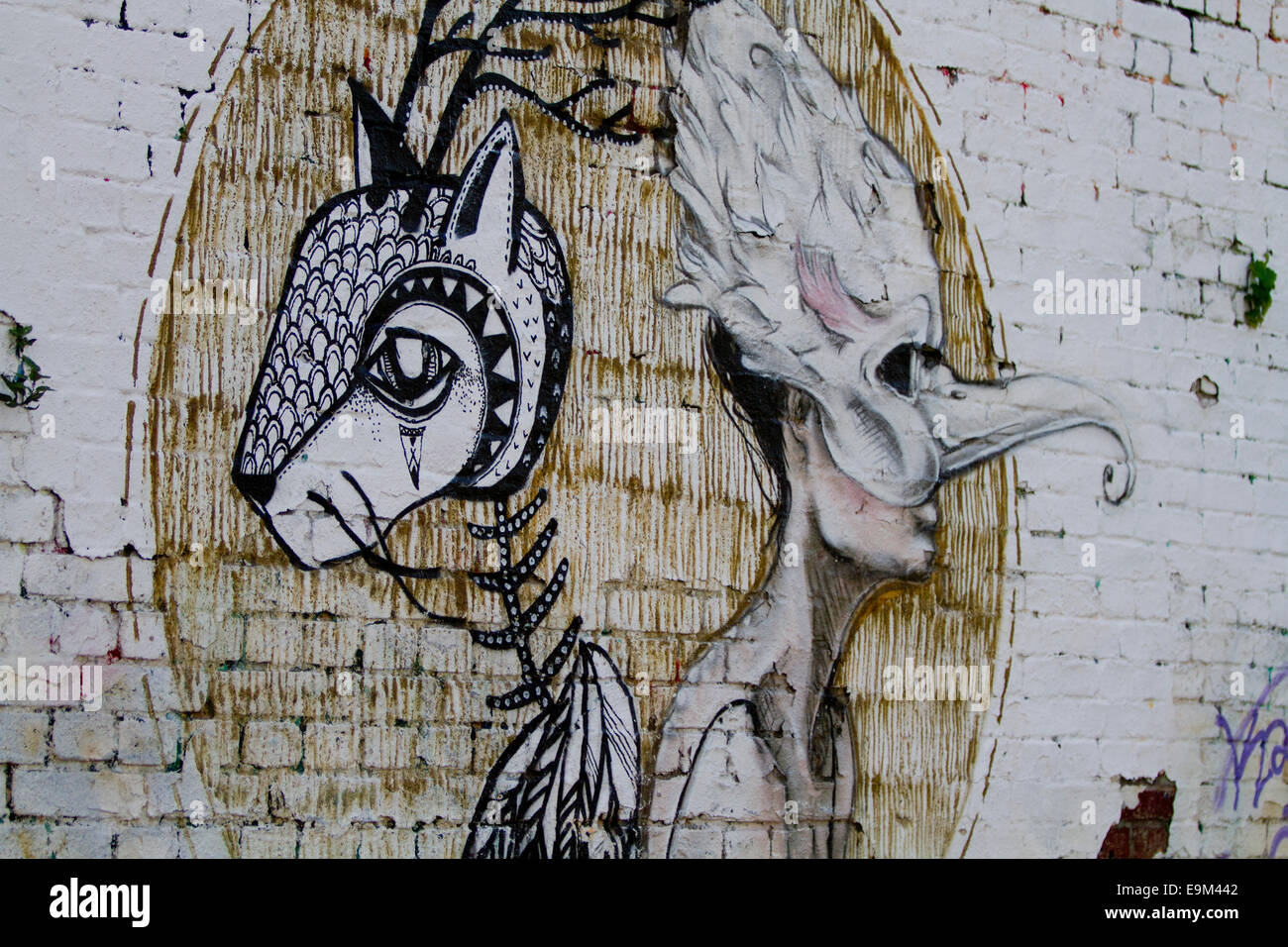 Graffiti street art Berlin Wall colour bricks mask Stock Photo