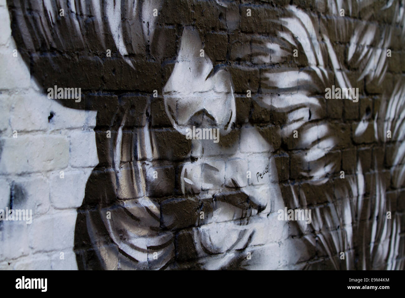 graffiti Berlin wall bricks womans face lips nose Stock Photo