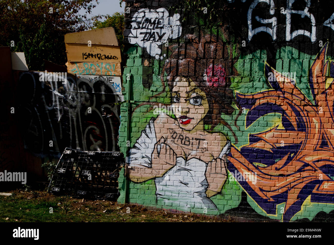 graffiti Berlin wall womans face bricks orbit some Stock Photo