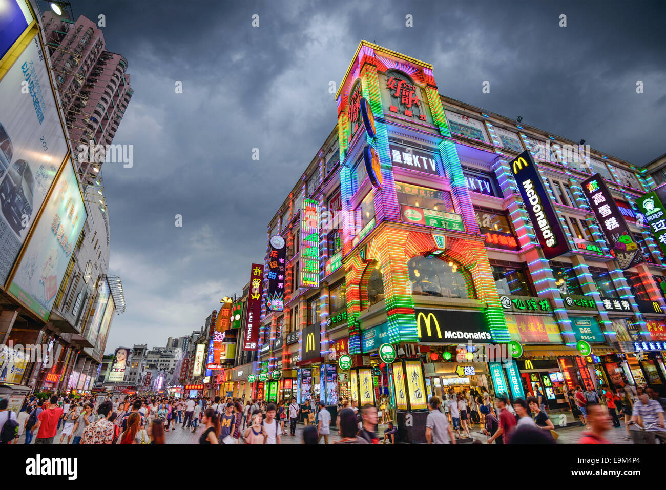 GUANGZHOU, CHINA - MAY 25, 2014: Pedestrians pass through Shangxiajiu Pedestrian Street. The street is the main shopping distric Stock Photo