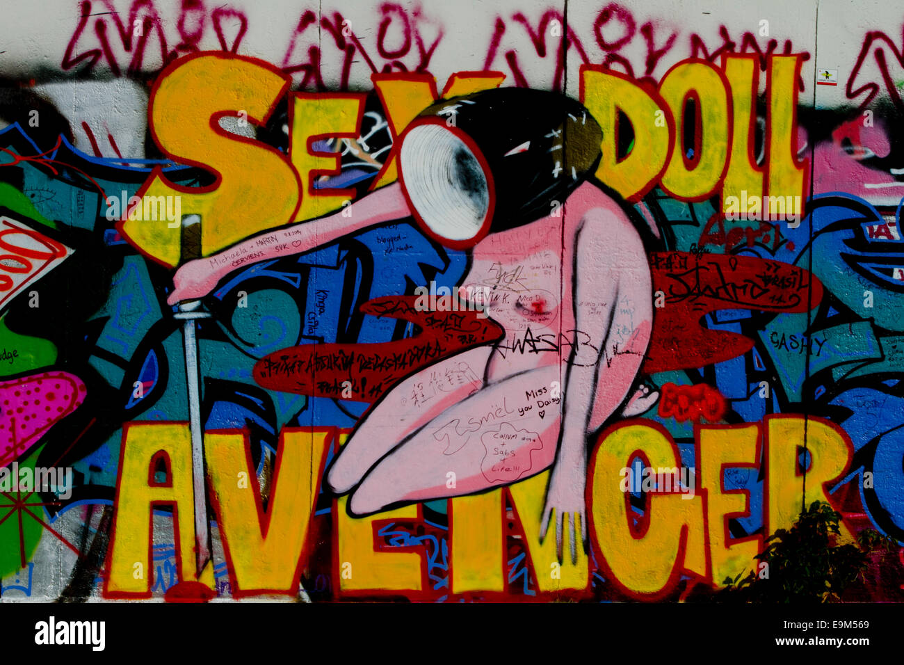 Graffiti street art Berlin Wall sex doll avenger Stock Photo - Alamy