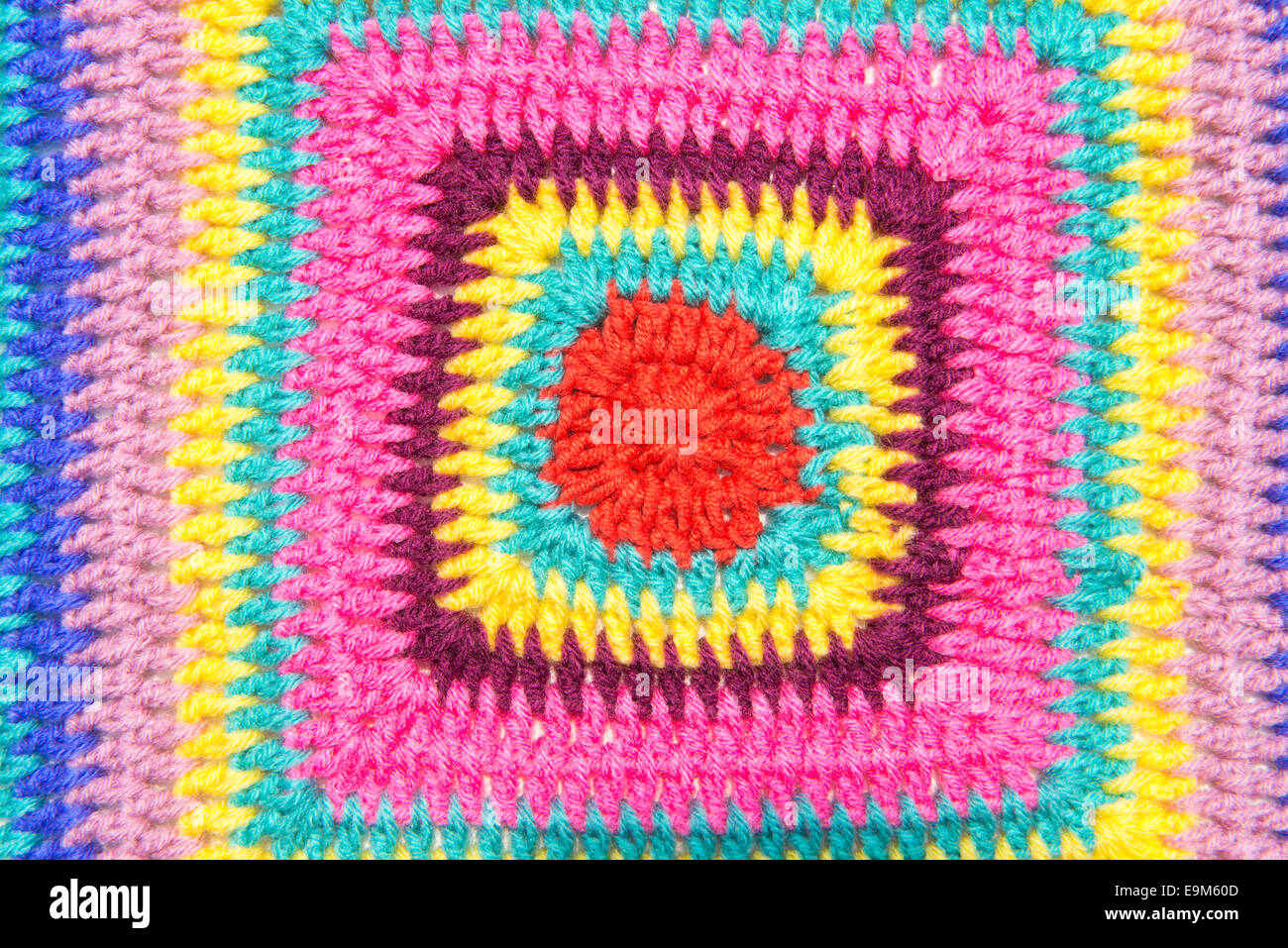 Colseup of crochet colorful fabric pattern. Homemade. Stock Photo
