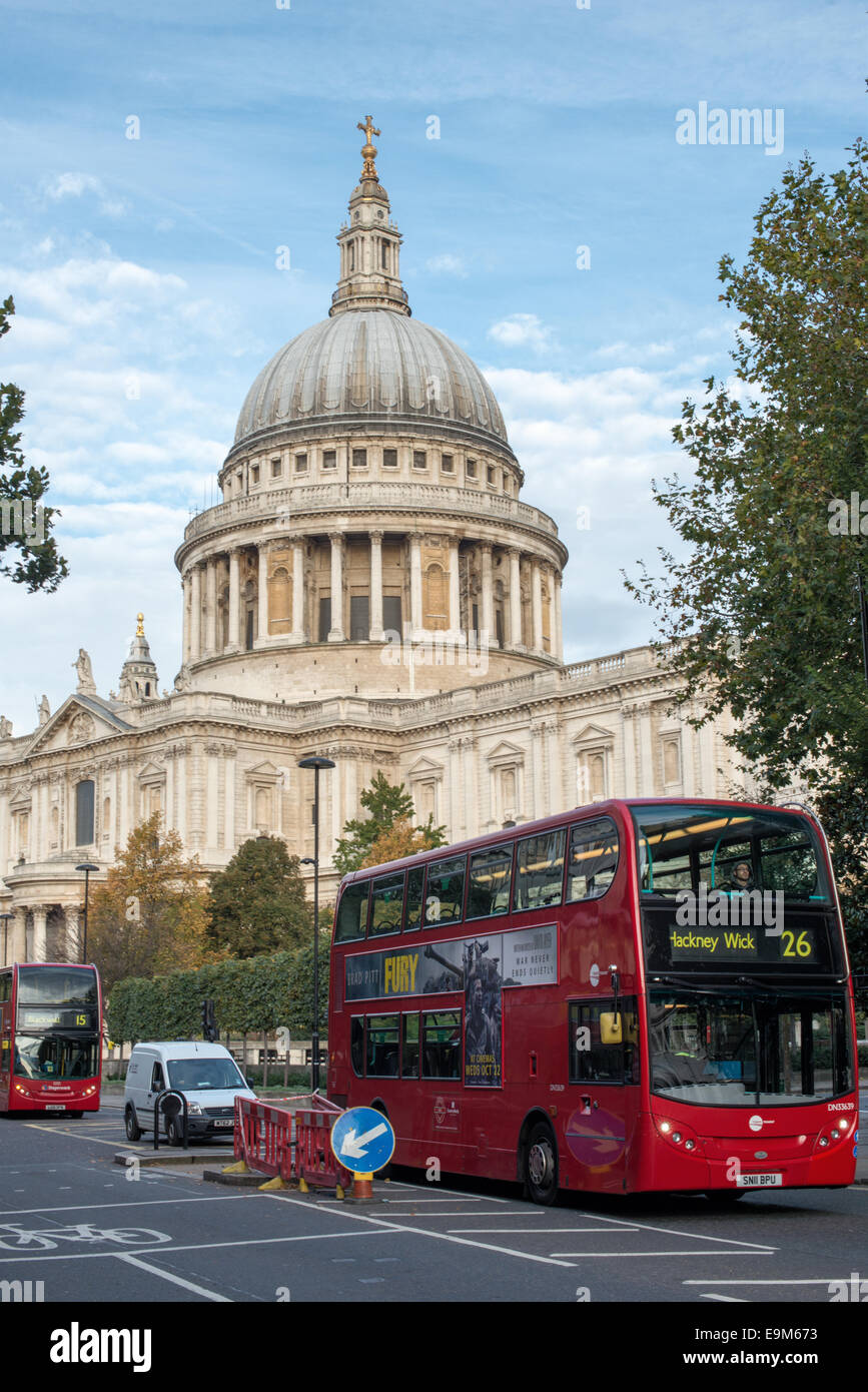 LONDON, UK - The iconic dome of St Paul's Cathedral in London, England, towers above the London buses below. Stock Photo