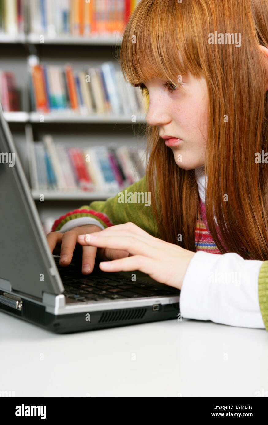 Girl in a library on laptop hi-res stock photography and images - Alamy