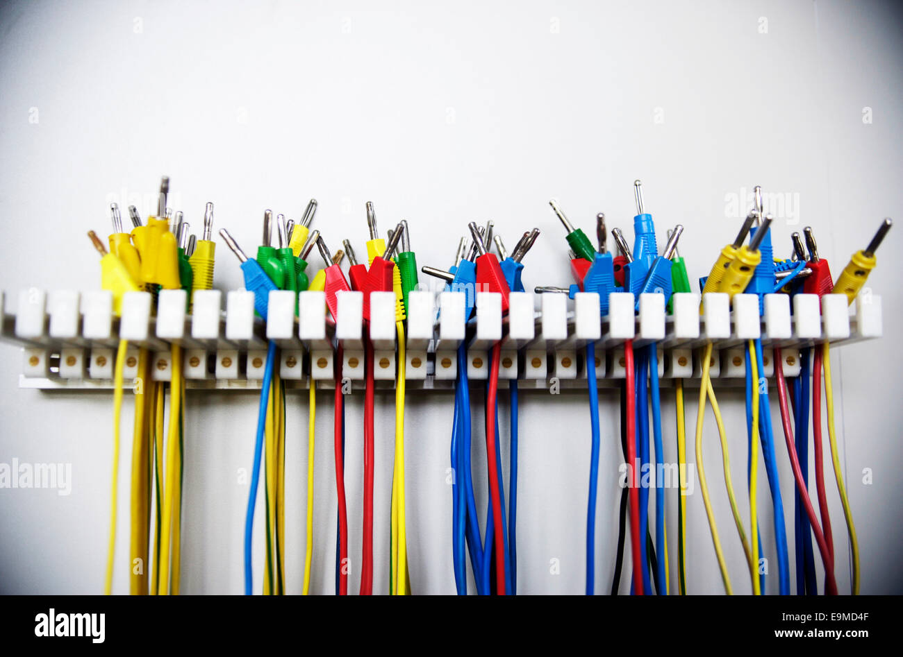 Several colorful cables hung on a stand Stock Photo