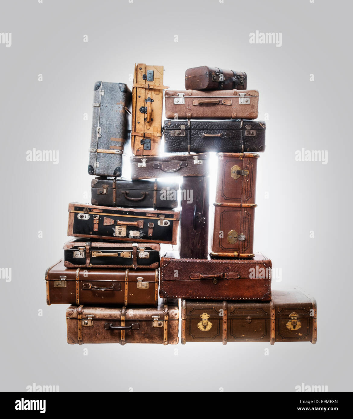 Stack of old suitcases over gray background Stock Photo