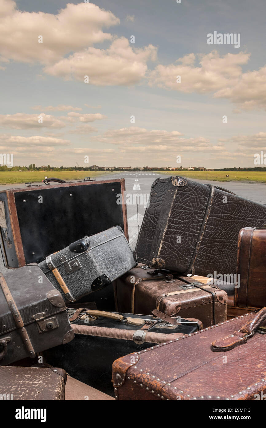 Old suitcases on street against sky Stock Photo